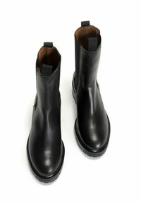 Black leather ankle boots with a smooth finish, rounded toe, and elastic side panels. Features pull tabs and textured rubber soles.