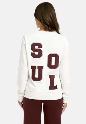 Weißer Sweatshirt mit großen burgunderfarbenen Blockbuchstaben, die "SOUL" auf dem Rücken buchstabieren. Rippbündchen und -saum. Glatte Textur.