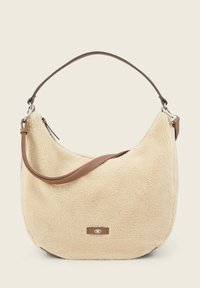 Beżowa torba hobo z sztucznego futerka z brązowym skórzanym paskiem, okrągły kształt, srebrne elementy metalowe oraz naszywka z logo z przodu.