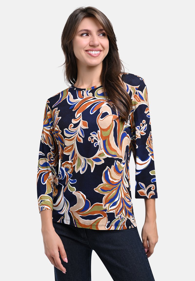 Navy blue long-sleeve shirt featuring a vibrant floral pattern in orange, green, and blue. Soft, lightweight fabric with a relaxed fit.