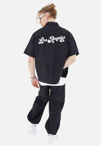 Megaman FREIZEI SET - Trousers - schwarz