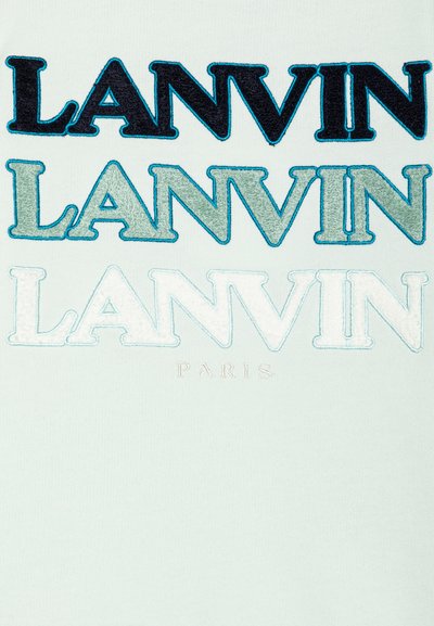 White textile featuring "LANVIN" embroidered in varying shades of blue and navy, with "PARIS" in smaller, light embroidery below.