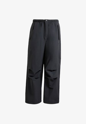Zwarte, ruime broek van zacht materiaal. Voorzien van een elastische tailleband, knoopsluiting en twee zijzakken met geplooide details.