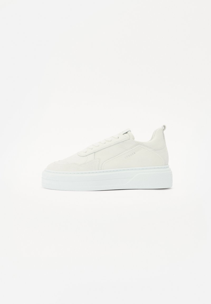 Baskets blanches avec une tige en daim texturé, des accents lisses, un design à lacets et une épaisse semelle en caoutchouc blanche. Comprend une languette à l'arrière.