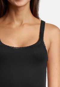 Black tank top featuring a fitted design, lace trim along the neckline and straps, and a smooth, soft texture.