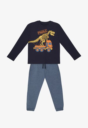 Langærmet navy top med et dinosaur grafik og "FRAGILE" tekst, parret med grå sweatpants med elastisk talje.