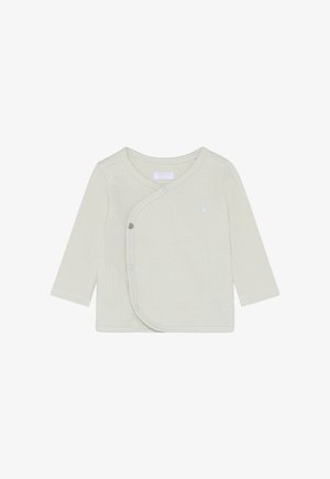 Baby cream-colored long-sleeve wrap shirt with textured fabric and snap buttons on the front left side.