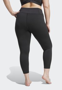 Mustad vöökohtadega mustad leggingud, valmistatud venivast materjalist. Omavad tagumist õmblust ja logo vöökoha lähedal, ulatudes kesk sääreni.