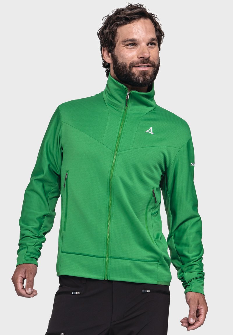 Grüner Reißverschlussjacke mit hohem Kragen, strukturiertem Stoff und zwei Seitentaschen. Mit einem stilisierten Logo auf der Brust.