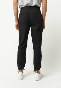 MELA RAJESH - Cargobroek - schwarz