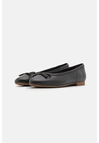 Ballerine in pelle nera con punta rotonda, dettagli decorativi a forma di fiocco e tacco in legno piatto. Texture liscia e design semplice.