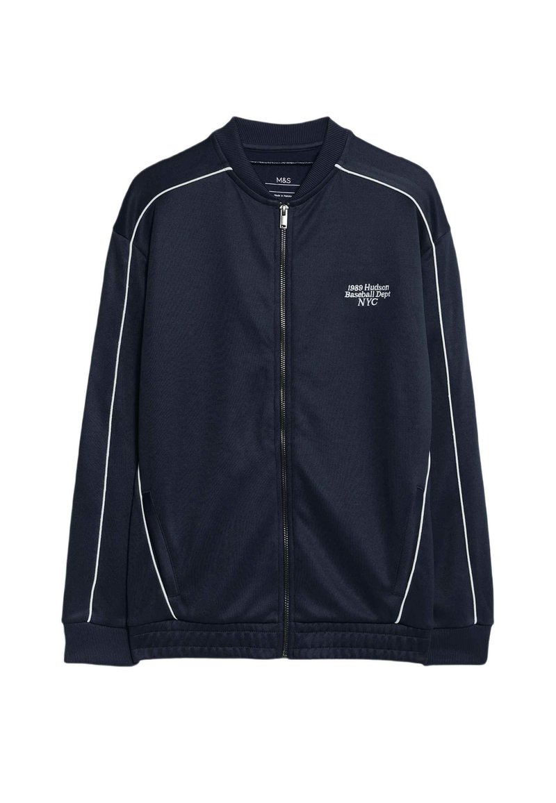 Giacca a zip blu navy realizzata in tessuto morbido con piping bianco a contrasto. Presenta un colletto rialzato e tasche frontali. Logo "1989 Hudson Baseball Dept NYC" sul petto.