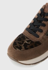 Baskets en daim marron avec des accents de léopard, lacets noirs et semelle en caoutchouc beige. Présente un dessus texturé pour un détail supplémentaire.