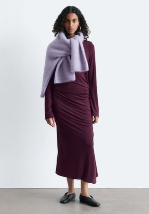 Burgundy long-sleeve dress with side ruching, paired with a soft lavender scarf. Black slip-on shoes complete the outfit.