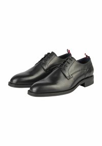Schwarze Leder-Halbschuhe mit glatter Textur, runder Zehenform und Schnürdesign. Verfügt über einen dezenten Absatz sowie rote und blaue Akzent-Schlaufen.