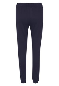 Mörk marinblå tapered sweatpants med elastisk midja och ankle cuffs, visade bakifrån mot en neutral vit bakgrund.