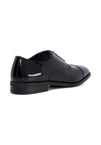 Black patent leather dress shoe with smooth texture, rounded toe, and a sleek heel. Features a lace-up design and subtle stitching details.