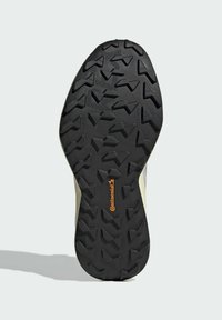 Black rubber shoe sole featuring a rugged tread pattern with multi-directional grips. Includes a Continental logo in orange.