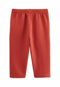 Pantalons en coton stretch rouge avec une taille élastique, texture côtelée et coupe ajustée, conçus pour le confort et la facilité de port.