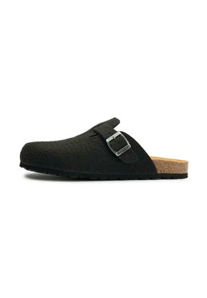 Black felt clog with a cork sole, adjustable strap featuring a silver buckle, rounded toe, and textured surface for grip.