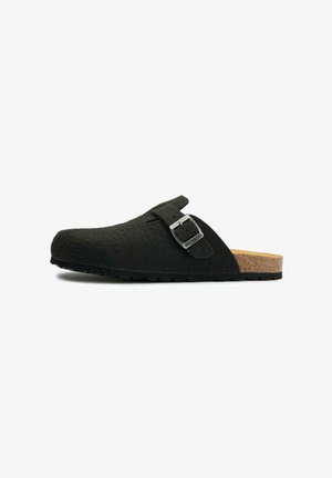 Black felt clog with a cork sole, adjustable strap featuring a silver buckle, rounded toe, and textured surface for grip.