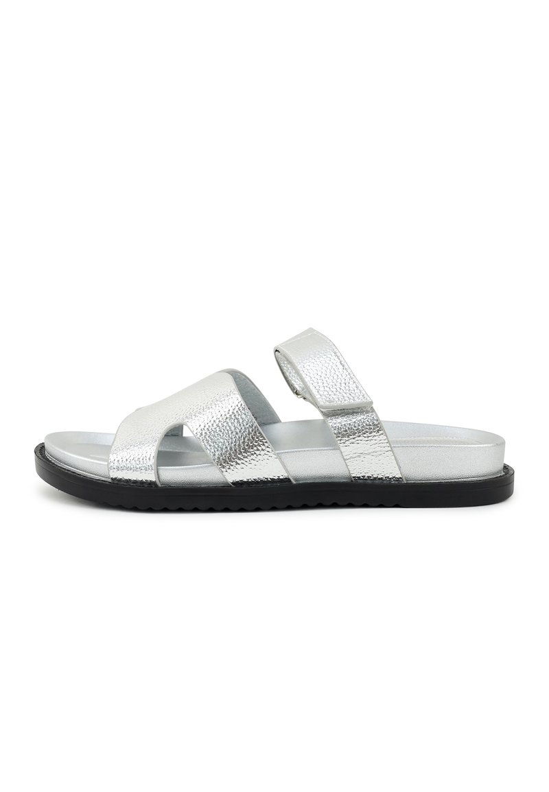 Silver metallic open-toe sandal with two wide straps and a Velcro ankle strap on a flat black rubber sole.