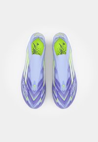 Purple and light blue athletic shoes with a textured surface, featuring bright green accents and a streamlined, slip-on design.