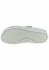 Suela de zapato blanca con una superficie de agarre texturizada con pequeñas protuberancias, un perímetro liso y un logotipo circular. Tamaño marcado como 37.