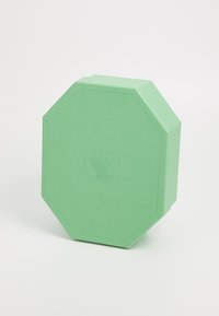 Grøn oktagonal kasse med en tekstureret finish og prægede logo. Designet fremhæver skarpe kanter og en solid form.