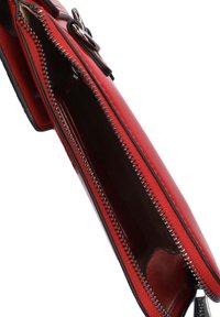 Red leather wallet with silver zipper, smooth texture, and interior compartments. Features a black accent strap and sturdy stitching.