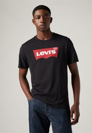Zwarte katoenen t-shirt met een opvallend rood Levi's logo in witte lettertypen. Korte mouwen en een ronde hals maken het ontwerp compleet.