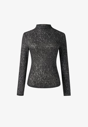 Haut noir à manches longues avec un col montant, présentant un motif texturé ressemblant à de la dentelle, réalisé dans un matériau doux et extensible.