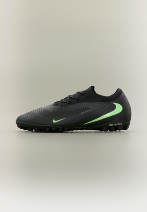 Sort atletisk skrue med neongrønne Nike-swooshes, tekstureret overdel, snørelukning og små gummitapper på sålen til trækkraft.
