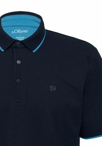 Navy polo shirt with a turquoise collar and inside collar accent; features three buttons and a logo on the left chest.