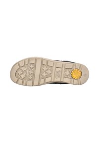 Black shoe sole with a textured beige rubber outsole. Features a yellow floral accent and multiple tread patterns for traction.