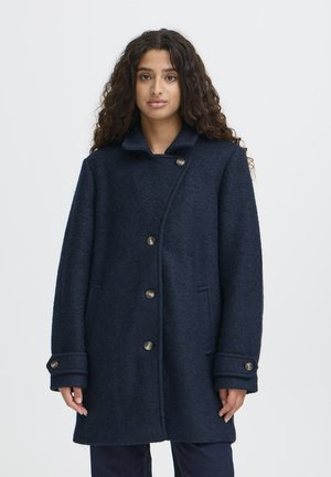 Marineblauwe wollen mix jas met een geknipt kraag, knopen aan de voorkant en zijzakken. Beschikt over een gestructureerde afwerking en cuffdetails.