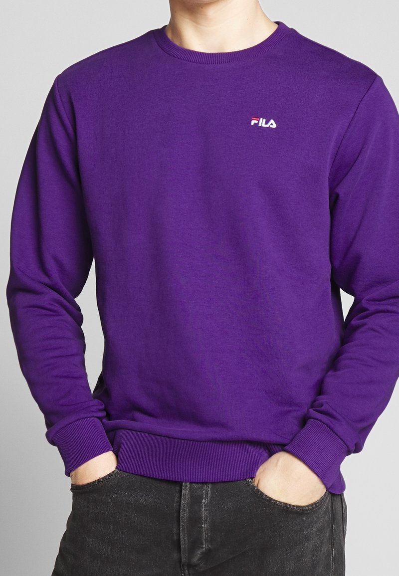Sweat-shirt violet à col rond en mélange de coton. Présente un petit logo Fila blanc sur la poitrine ainsi que des poignets et un ourlet côtelés.