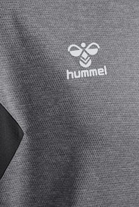 Maglietta sportiva grigia con tessuto testurizzato, dettagli neri e un logo bianco con un disegno di ape e la parola "hummel" sottostante.
