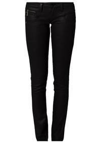 Pantalones vaqueros negros ajustados con una textura suave, con bolsillos frontales y un detalle con cremalleras en el muslo izquierdo. Diseño ajustado.