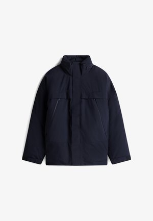 Dark blue insulated jacket with a high collar, two front pockets, and contrasting zippers. Durable fabric, straight cut, and minimal detailing.