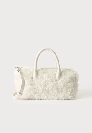 Small white handbag with curly fur texture, dual handles, and a detachable shoulder strap against a plain light background.