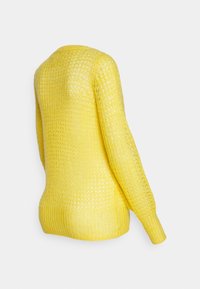 Yellow knit sweater with a loose, open weave, ribbed hem and cuffs, featuring a slightly curved neckline and long sleeves.