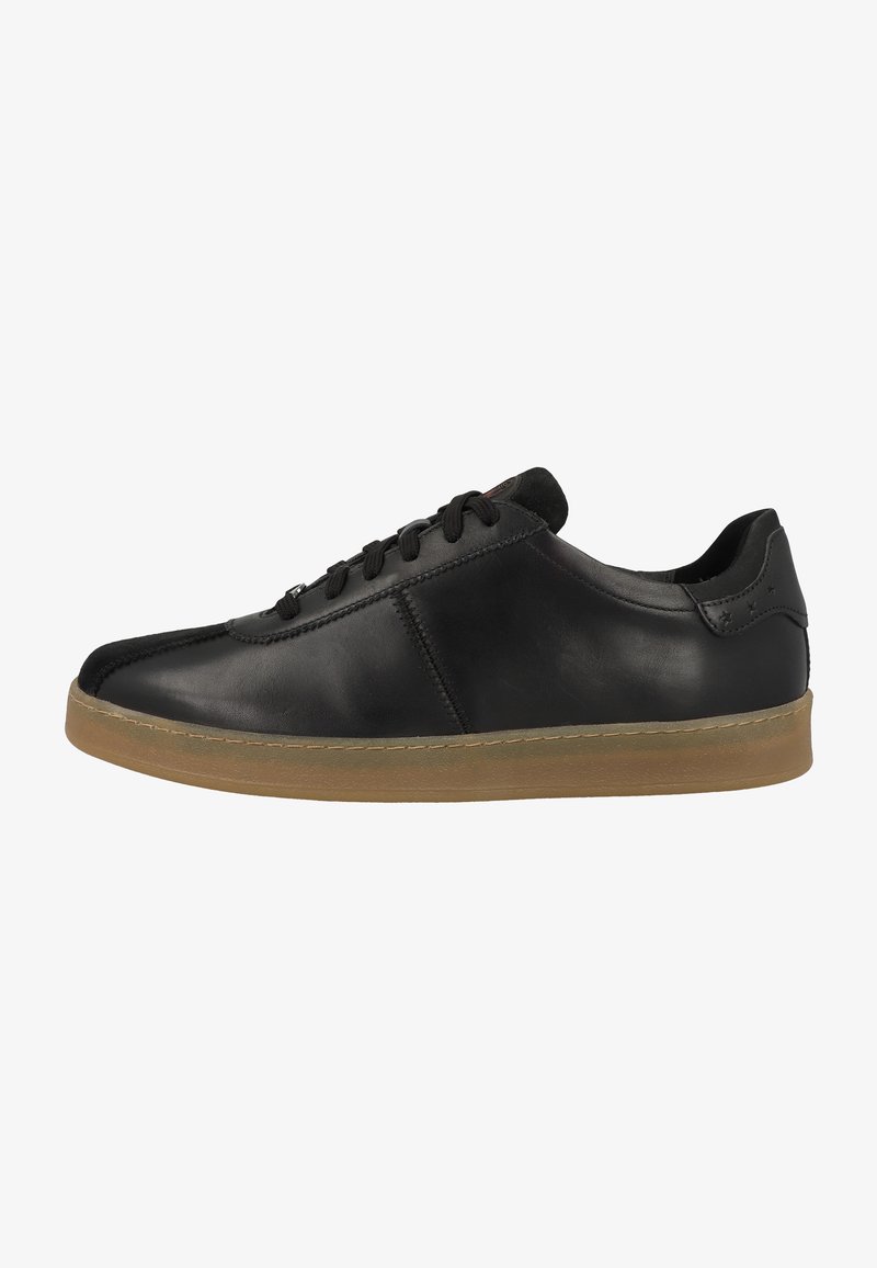 Black leather sneaker with a rounded toe, textured surface, and a gum rubber sole. Features flat black laces and a low ankle design.