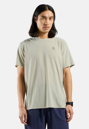 Light green, short-sleeved T-shirt made of a smooth, moisture-wicking fabric. Features subtle logo on chest and relaxed fit design.