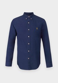 Navy long-sleeve shirt made of cotton. Features a button-down collar, front buttons, and a small golden logo on the chest. Smooth texture.