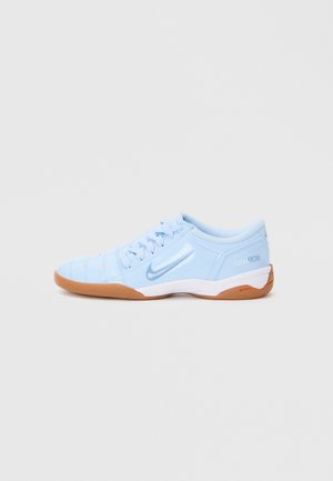 Light blue athletic shoe with a smooth synthetic upper, textured accents, and a gum rubber outsole. Features a logo on the side.