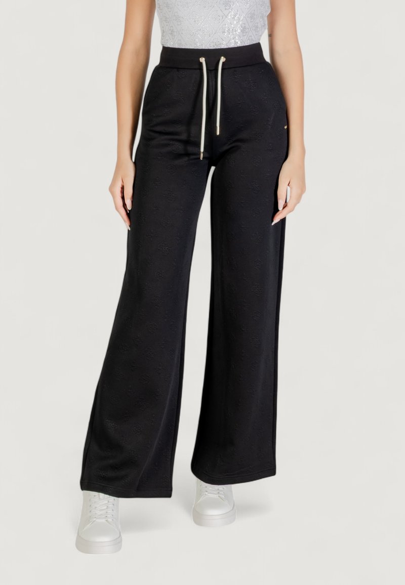 Pantaloni neri a gamba ampia realizzati in tessuto testurizzato con vita elastica e cordoncino. Presentano dettagli in metallo dorato.