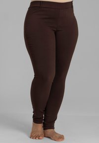 Braune, eng anliegende Leggings mit glatter Textur, ausgestattet mit einem hohen Bund und knöchellanger Schnitt, ideal für die Freizeit.