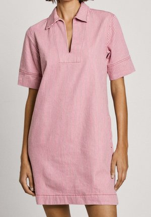 Short-sleeve dress in red and white stripes, collared neckline, subtle side slits, and a single front pocket for added detail.