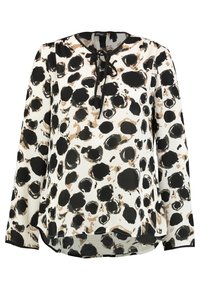 Blouse à manches longues en tissu léger avec une base blanche, présentant de grands motifs circulaires noirs et marron. Liens au col et ourlet arrondi.